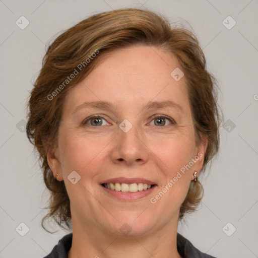 Joyful white adult female with medium  brown hair and blue eyes