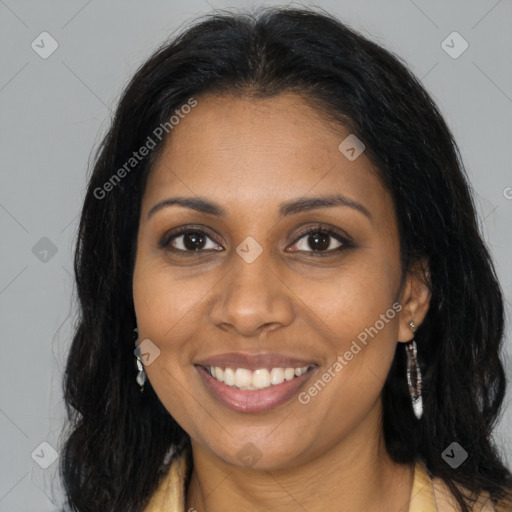 Joyful black young-adult female with long  brown hair and brown eyes