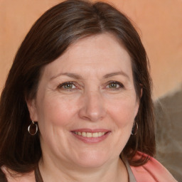 Joyful white adult female with medium  brown hair and brown eyes