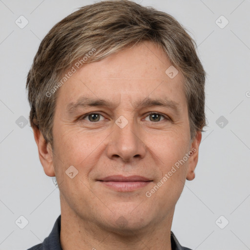 Joyful white adult male with short  brown hair and grey eyes