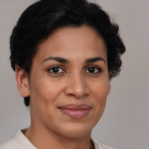 Joyful black adult female with short  brown hair and brown eyes