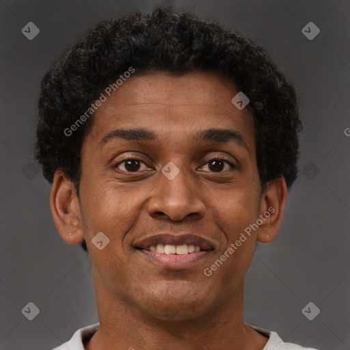 Joyful black young-adult male with short  brown hair and brown eyes