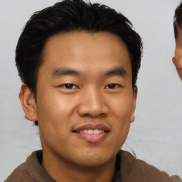 Joyful asian young-adult male with short  black hair and brown eyes