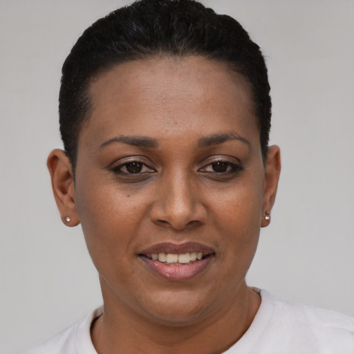 Joyful black young-adult female with short  black hair and brown eyes