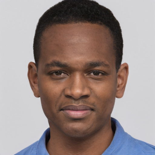 Joyful black young-adult male with short  brown hair and brown eyes