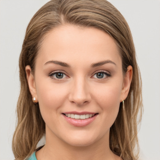 Joyful white young-adult female with long  brown hair and grey eyes