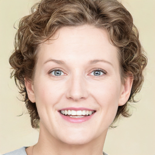 Joyful white young-adult female with medium  brown hair and blue eyes