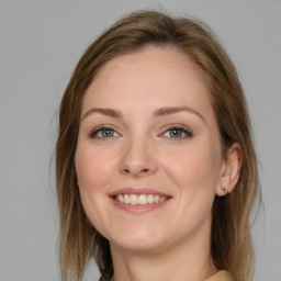 Joyful white young-adult female with medium  brown hair and grey eyes