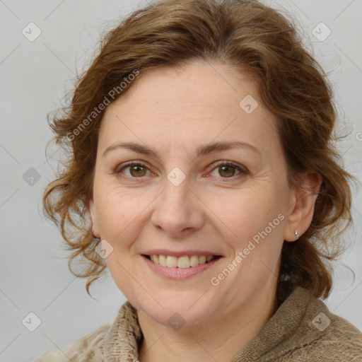 Joyful white adult female with medium  brown hair and blue eyes