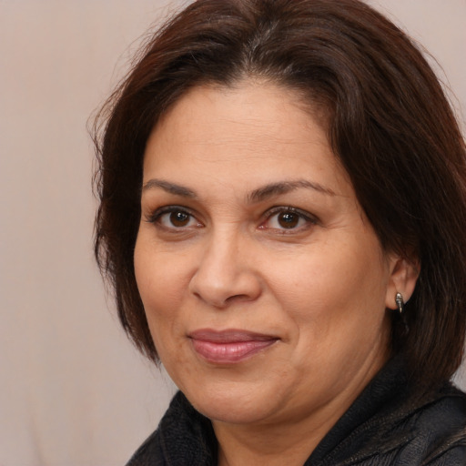 Joyful white adult female with medium  brown hair and brown eyes