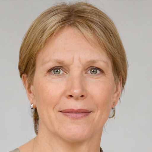 Joyful white adult female with medium  brown hair and blue eyes