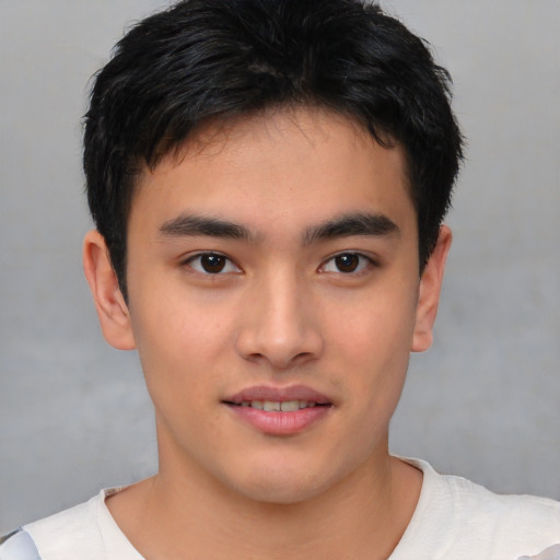 Joyful asian young-adult male with short  brown hair and brown eyes