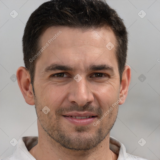 Joyful white adult male with short  brown hair and brown eyes