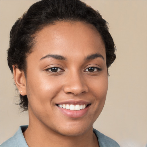 Joyful latino young-adult female with short  brown hair and brown eyes