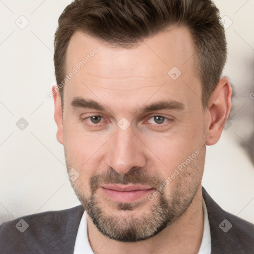 Joyful white adult male with short  brown hair and brown eyes