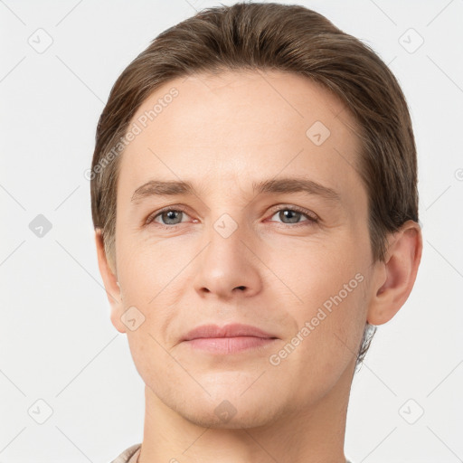 Joyful white young-adult male with short  brown hair and grey eyes