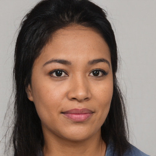 Joyful asian young-adult female with long  brown hair and brown eyes