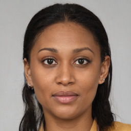 Joyful latino young-adult female with long  brown hair and brown eyes