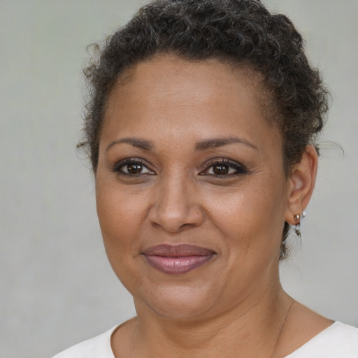 Joyful black adult female with short  brown hair and brown eyes