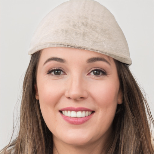 Joyful white young-adult female with long  brown hair and grey eyes