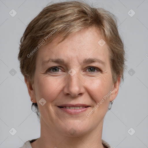 Joyful white adult female with short  brown hair and grey eyes