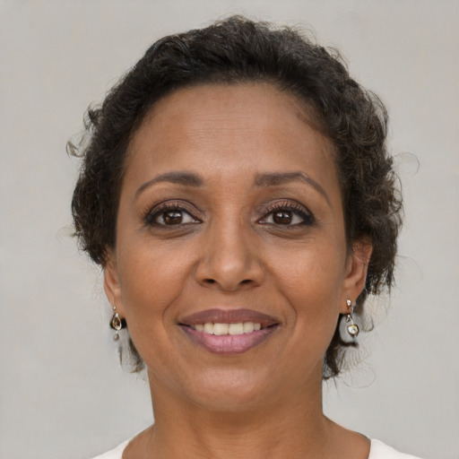 Joyful black adult female with short  brown hair and brown eyes
