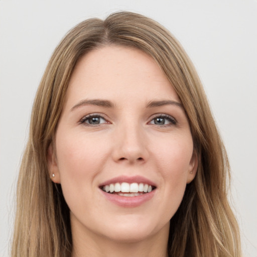 Joyful white young-adult female with long  brown hair and green eyes