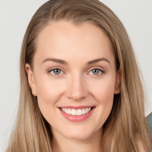 Joyful white young-adult female with long  brown hair and grey eyes