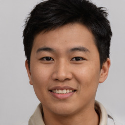 Joyful asian young-adult male with short  brown hair and brown eyes