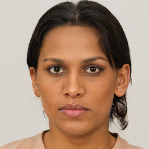 Neutral black young-adult female with medium  brown hair and brown eyes