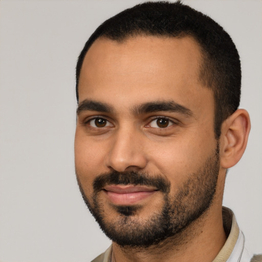 Joyful latino young-adult male with short  black hair and brown eyes