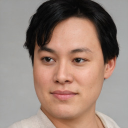 Joyful asian young-adult male with short  brown hair and brown eyes