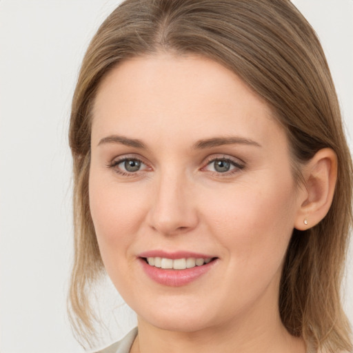 Joyful white young-adult female with long  brown hair and grey eyes