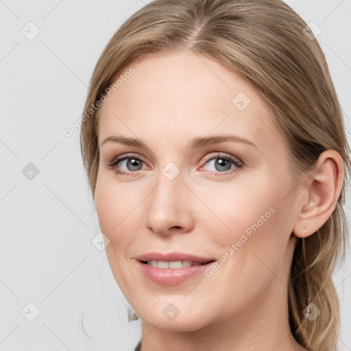 Joyful white young-adult female with medium  brown hair and blue eyes