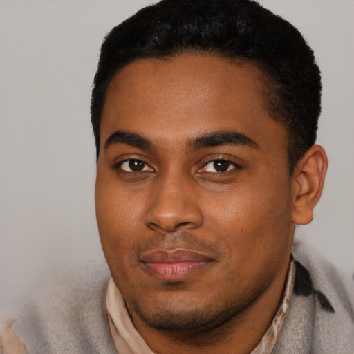 Joyful black young-adult male with short  black hair and brown eyes
