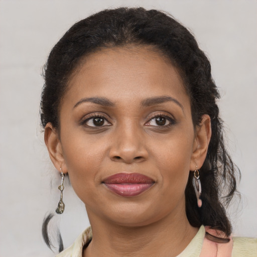 Joyful black young-adult female with medium  brown hair and brown eyes