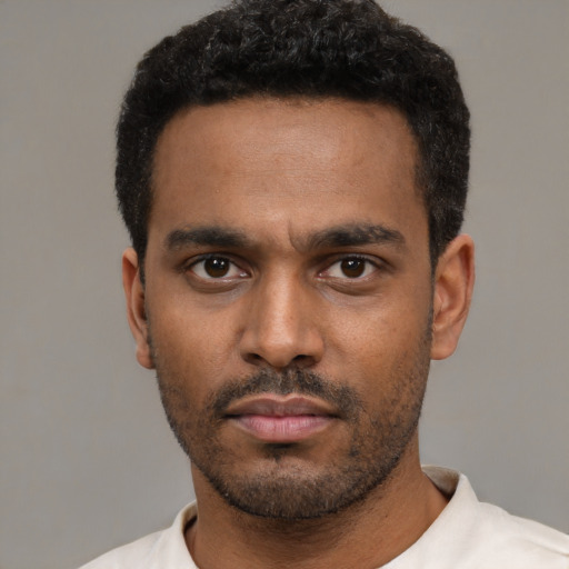 Neutral latino young-adult male with short  black hair and brown eyes