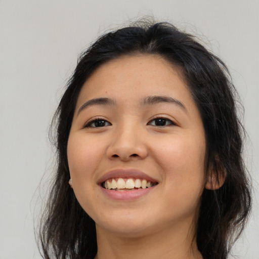 Joyful white young-adult female with long  brown hair and brown eyes