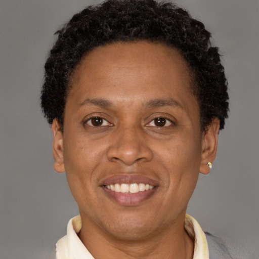 Joyful latino adult female with short  brown hair and brown eyes