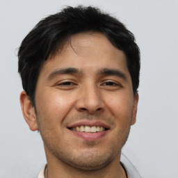 Joyful asian young-adult male with short  brown hair and brown eyes