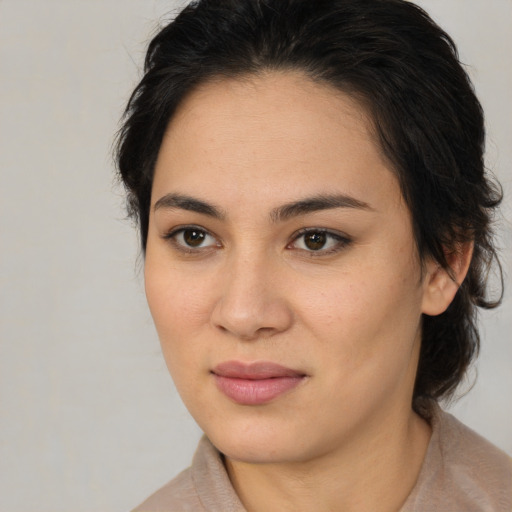 Joyful latino young-adult female with medium  brown hair and brown eyes