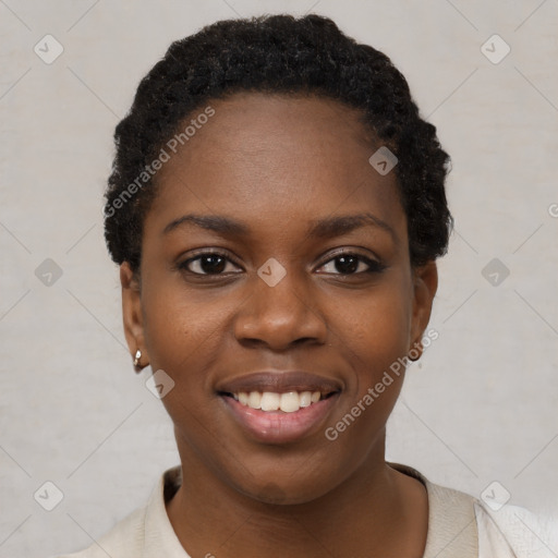 Joyful black young-adult female with short  black hair and brown eyes