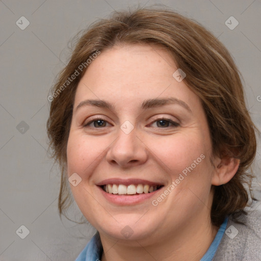 Joyful white adult female with medium  brown hair and blue eyes