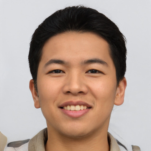 Joyful asian young-adult male with short  black hair and brown eyes