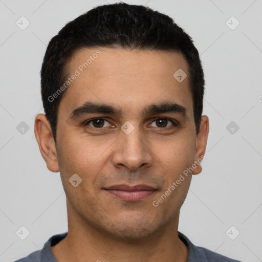 Joyful white young-adult male with short  black hair and brown eyes