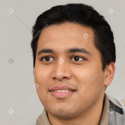 Joyful latino young-adult male with short  black hair and brown eyes