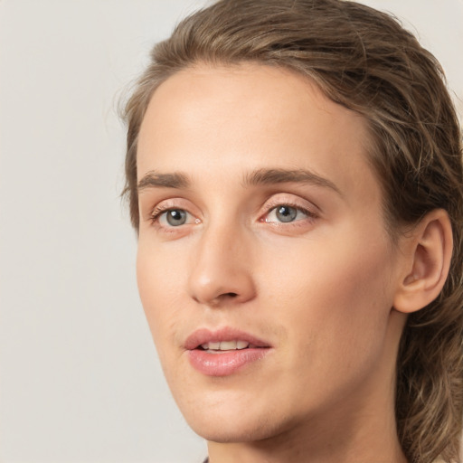 Joyful white young-adult female with medium  brown hair and green eyes