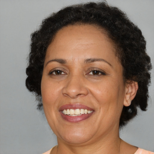 Joyful black adult female with short  brown hair and brown eyes