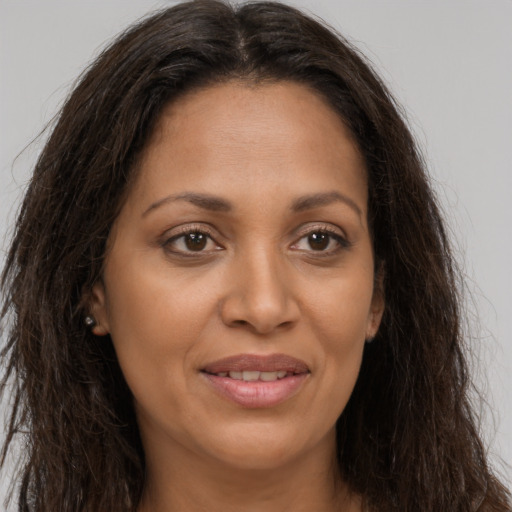Joyful latino young-adult female with long  brown hair and brown eyes