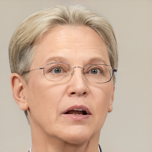 Joyful white middle-aged female with short  blond hair and blue eyes